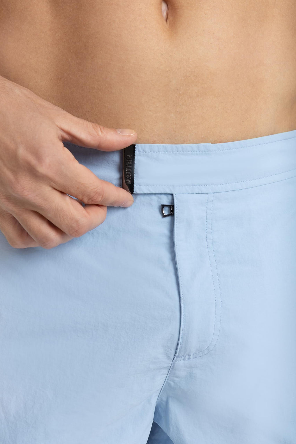 Detalhe da cintura do short RAUTER AZUL BEBÊ MÉDIO com fivela ajustável em nylon reciclado.